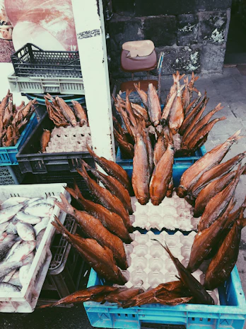 A smiling staff member carefully packaging smoked fish for online orders.