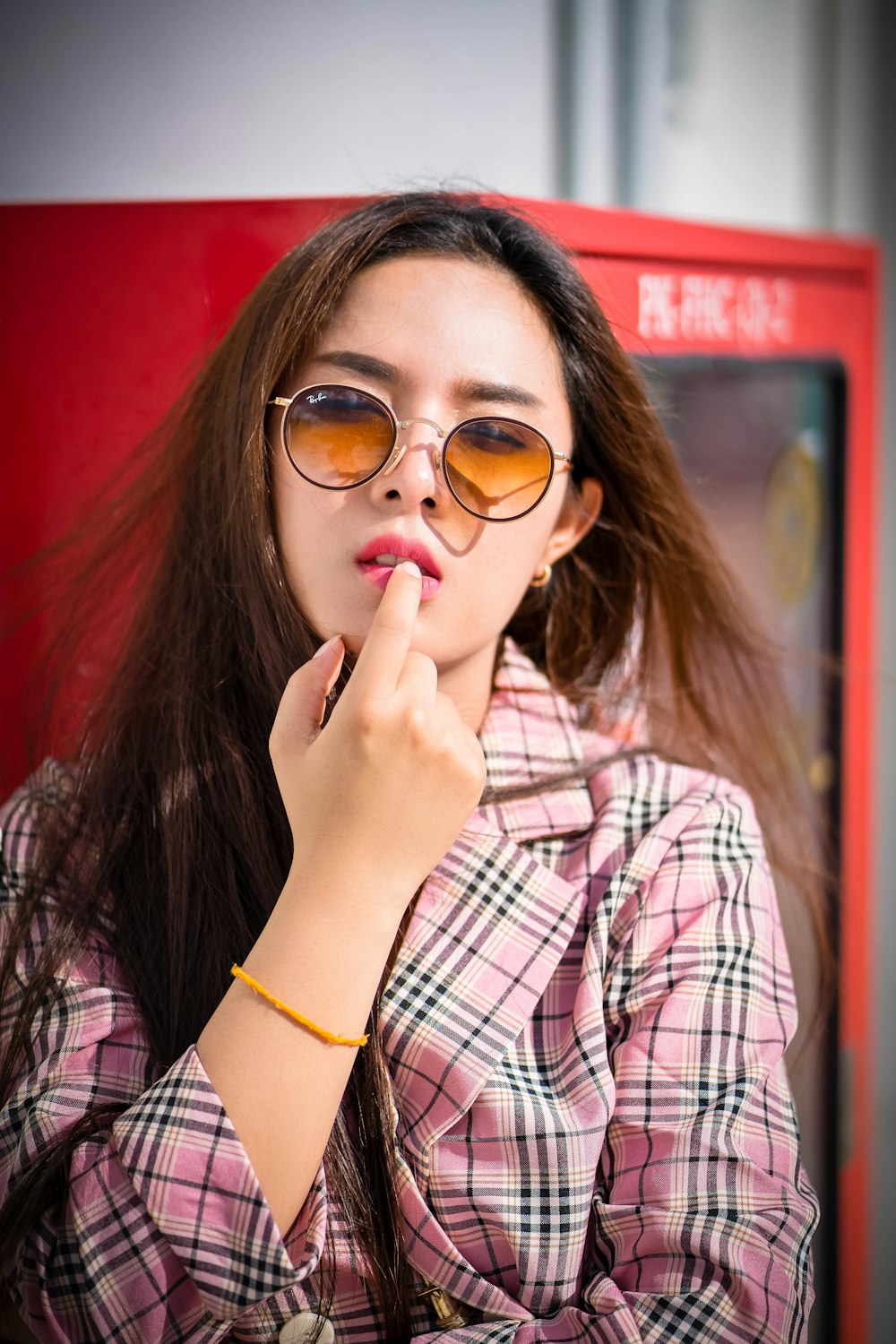 woman in pink and black plaid dress shirt