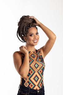Woman smiling while applying pomada modeladora on her braided hair