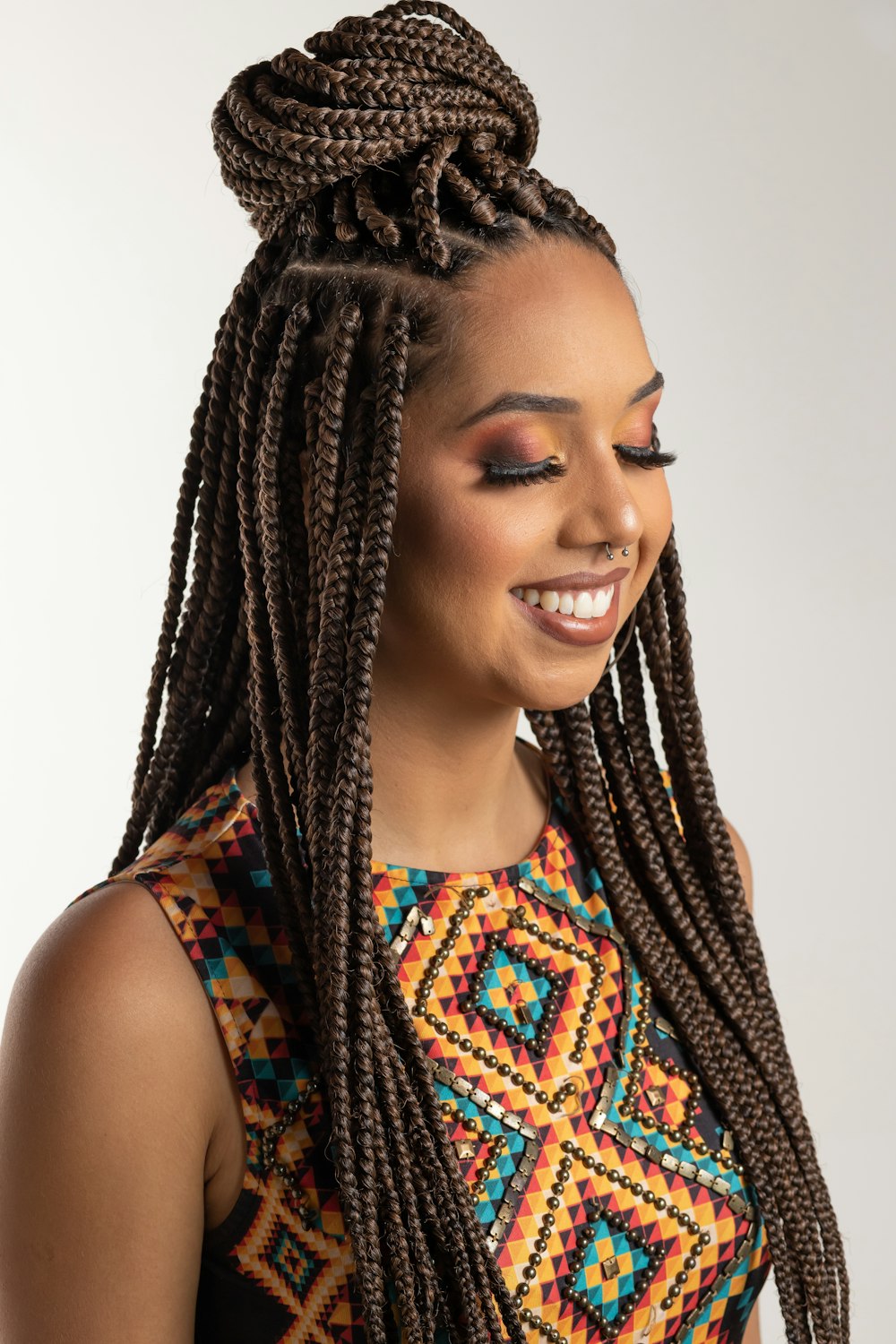 woman wearing multicolored blouse and braided hair