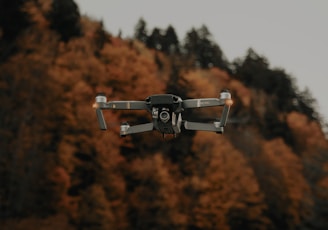 selective-focus of photography of black drone near winding road