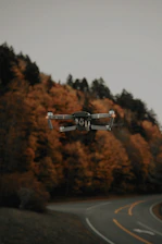 selective-focus of photography of black drone near winding road