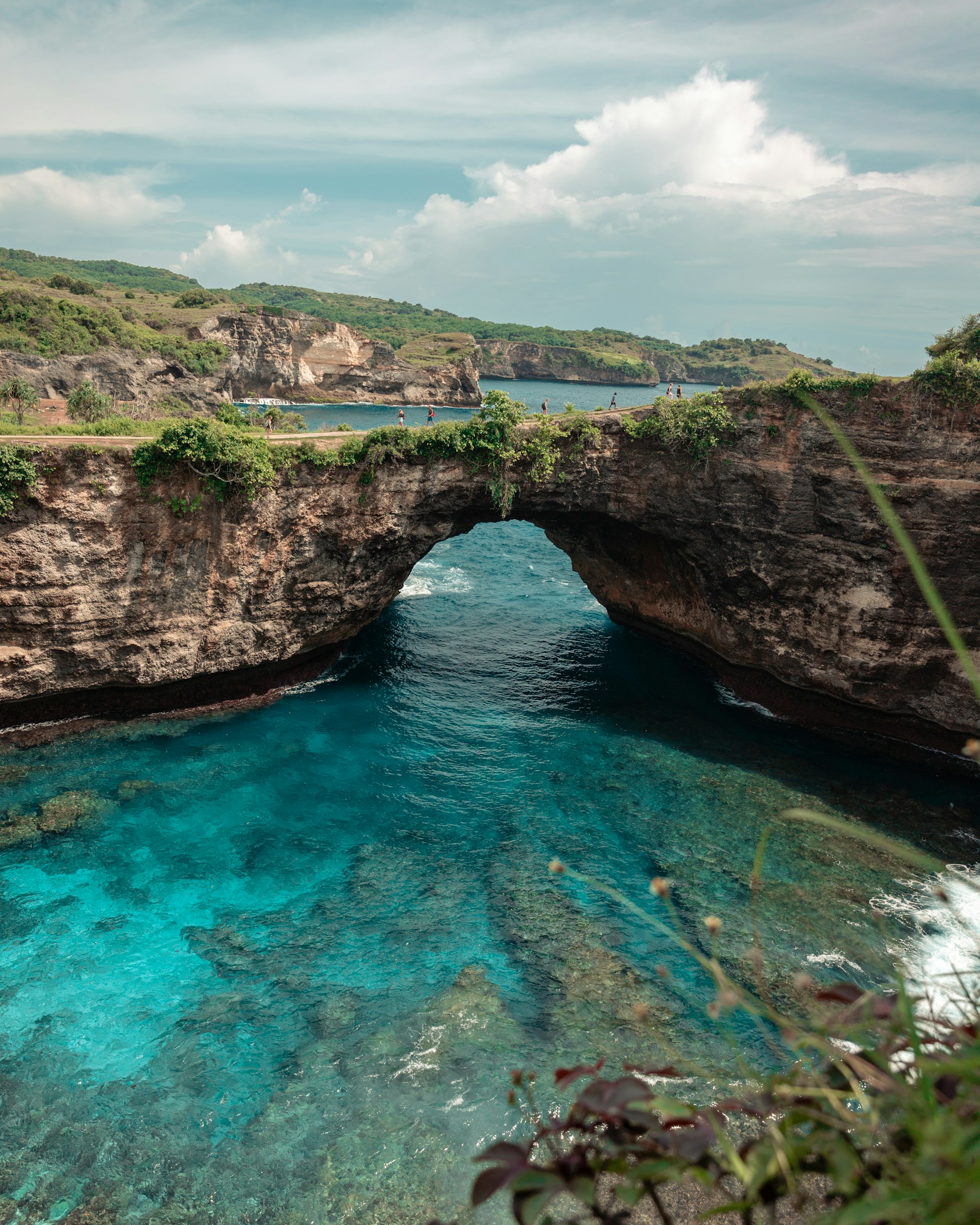 blue body of water near mountain
