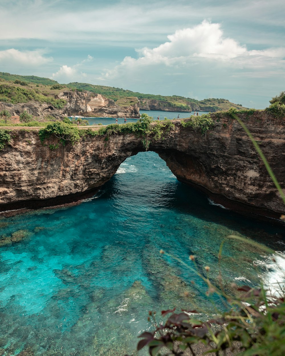 blue body of water near mountain