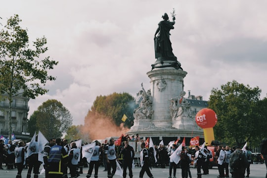 people walking beside male statue during daytime in Place de la République France