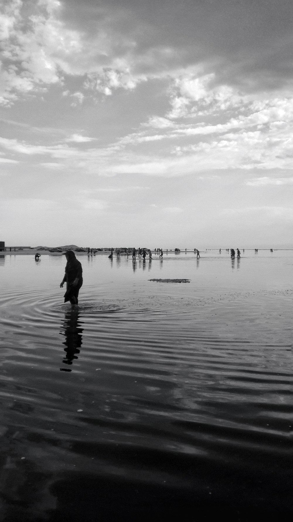 grayscale photo of woman on seashore