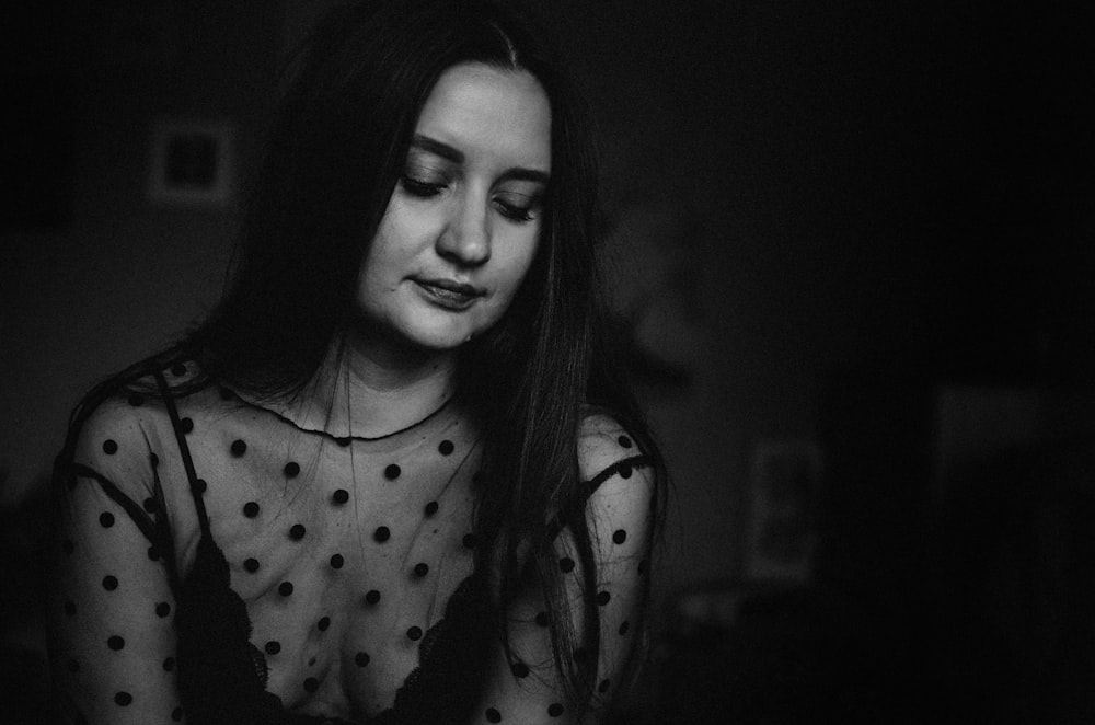 grayscale photo of polka-dot illusion-neckline top