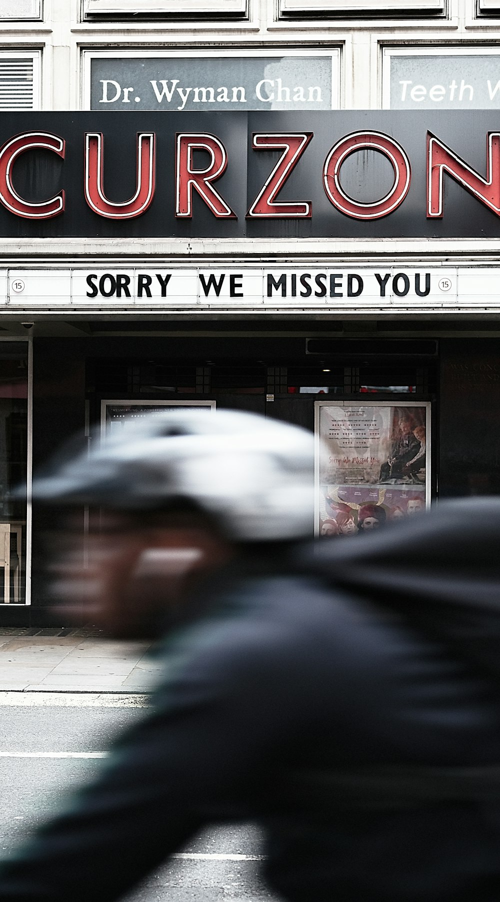 man passing by Curzon building