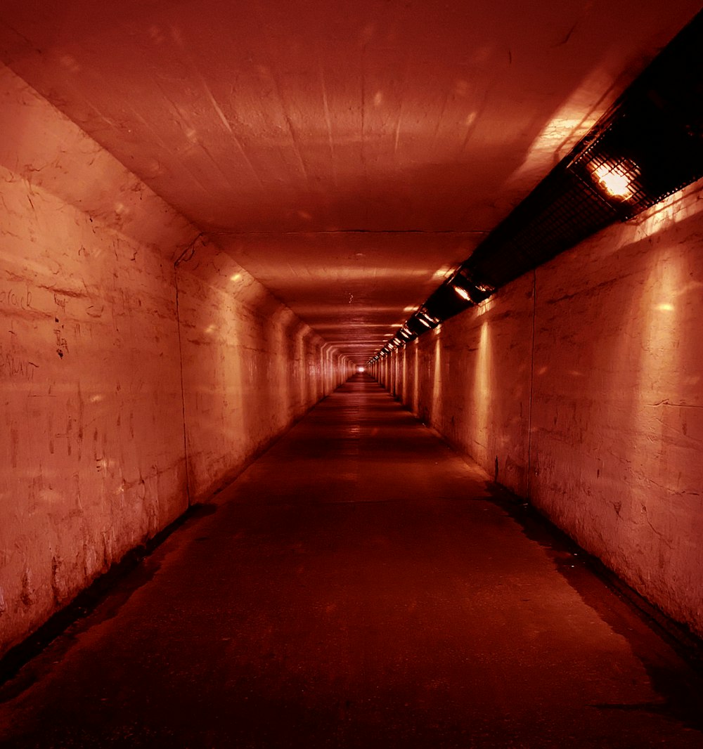 concrete tunnel with red lights