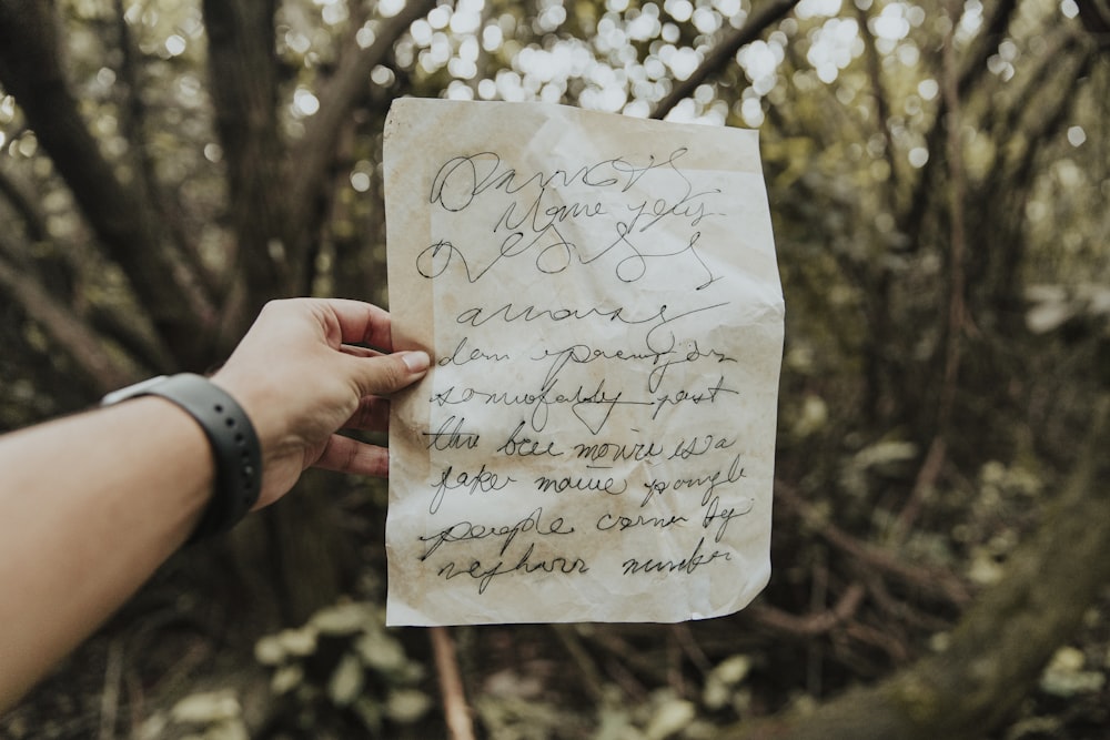 person holding white printer paper