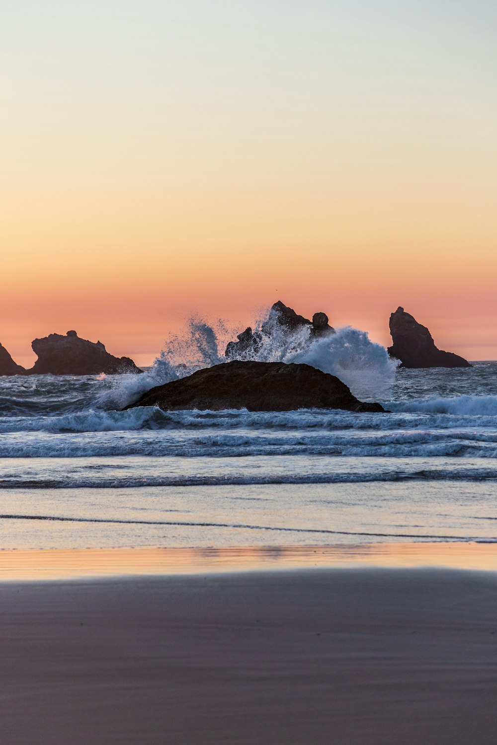 rock formation on the body of water photograph