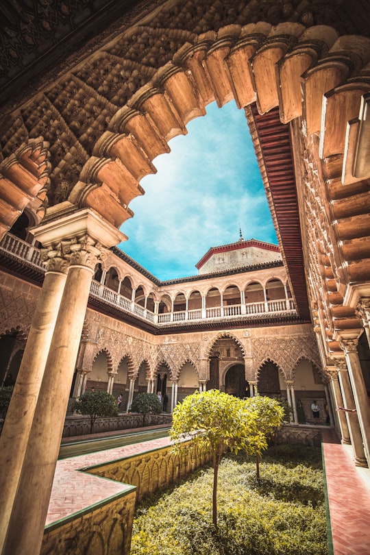 brown concrete 3-storey house in Alcázar of Seville Spain