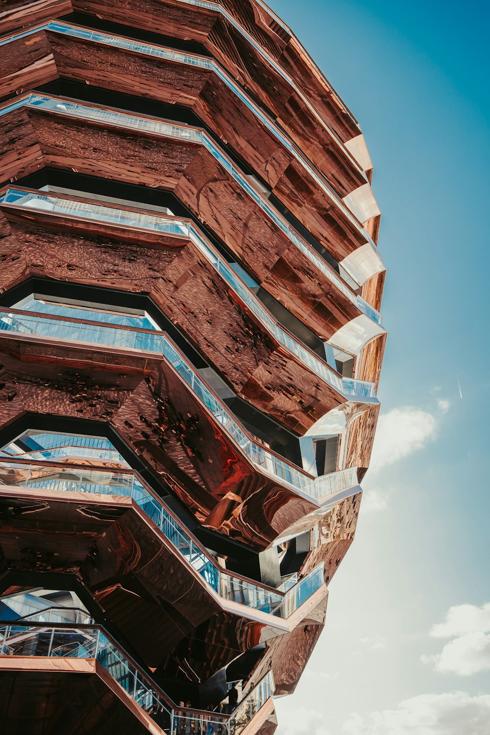 low-angle photography of brown and gray building under blue sky