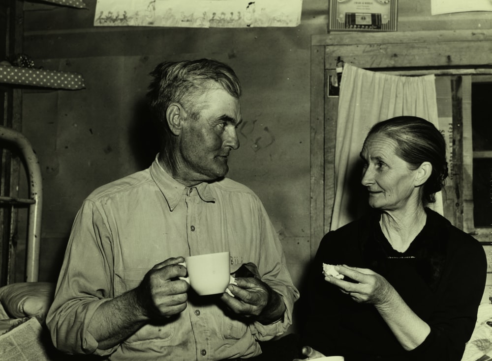 grayscale photography of man and woman beside each other