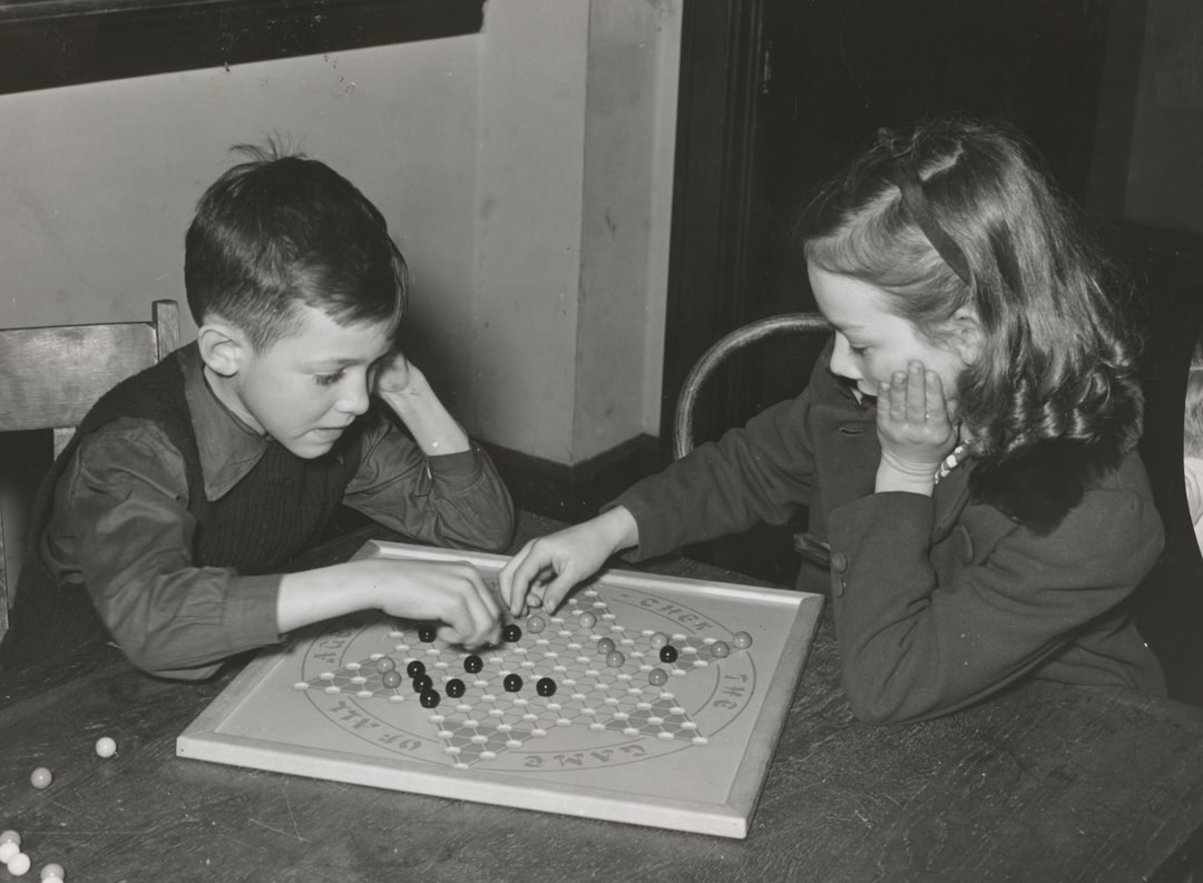 girl and boy playing chess board