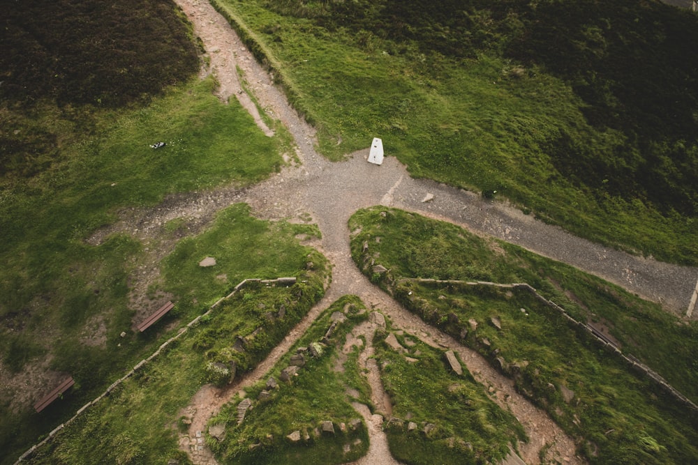 an aerial view of a grassy area with a white building