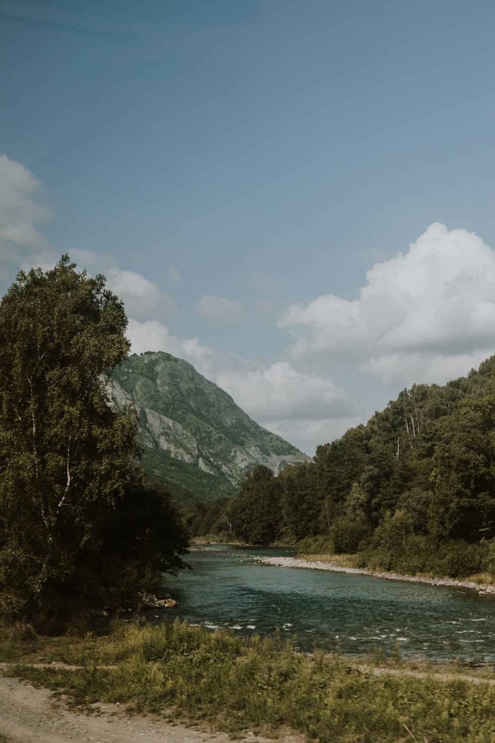 river near mountain at daytimwe