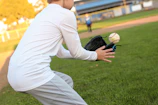 A professional baseball glove catching a fast-moving ball in mid-air.