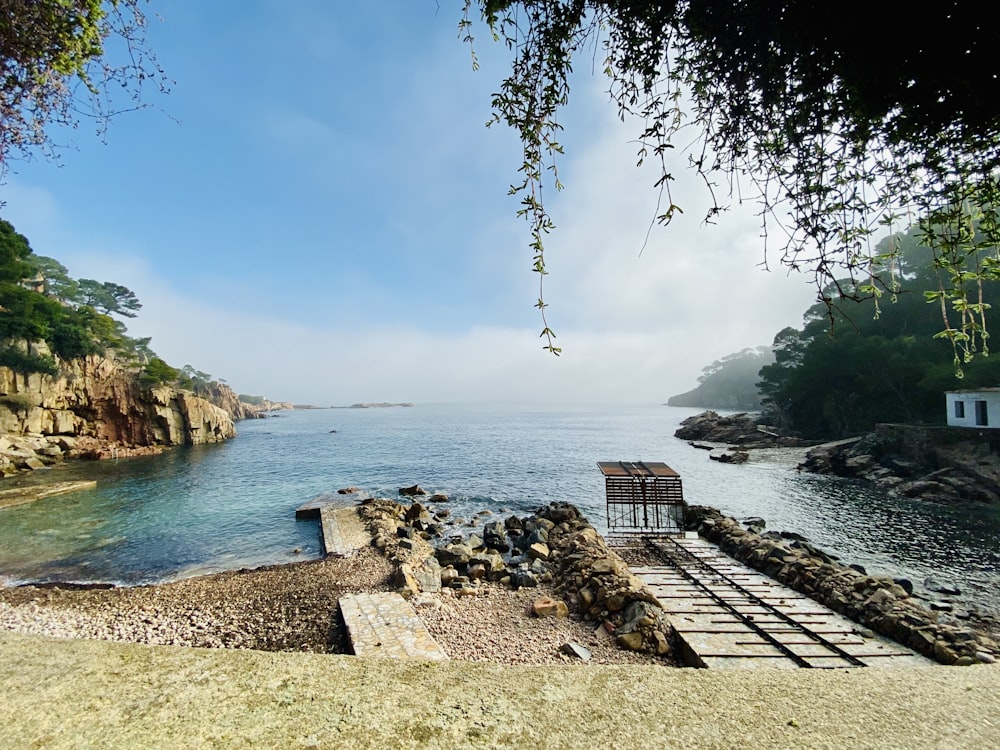 brown wooden dock bridge near body of water