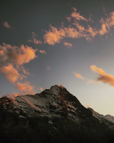 Sunset casting warm hues over a glacier’s textured surface, highlighting its rugged beauty.