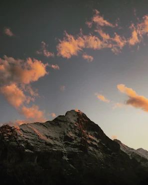 Sunset casting golden light on the snow-capped Jade Dragon Snow Mountain.