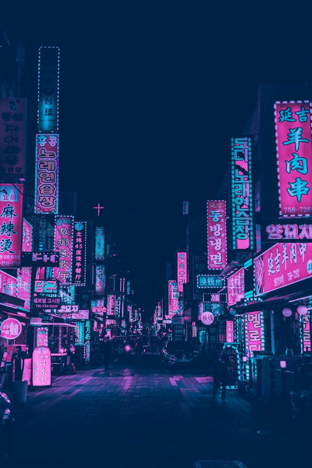 pink and white neon signs of buildings at night