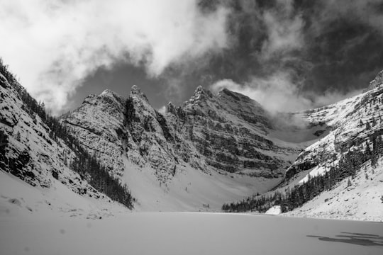 grayscale photo of hill covered with snow in Lake Agnes Canada
