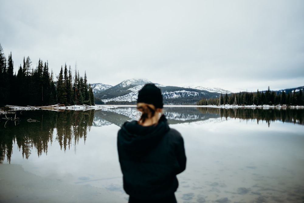 woman standing infront of body of water