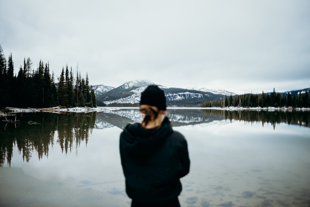 woman standing infront of body of water, Start of winter at Sparks Lake