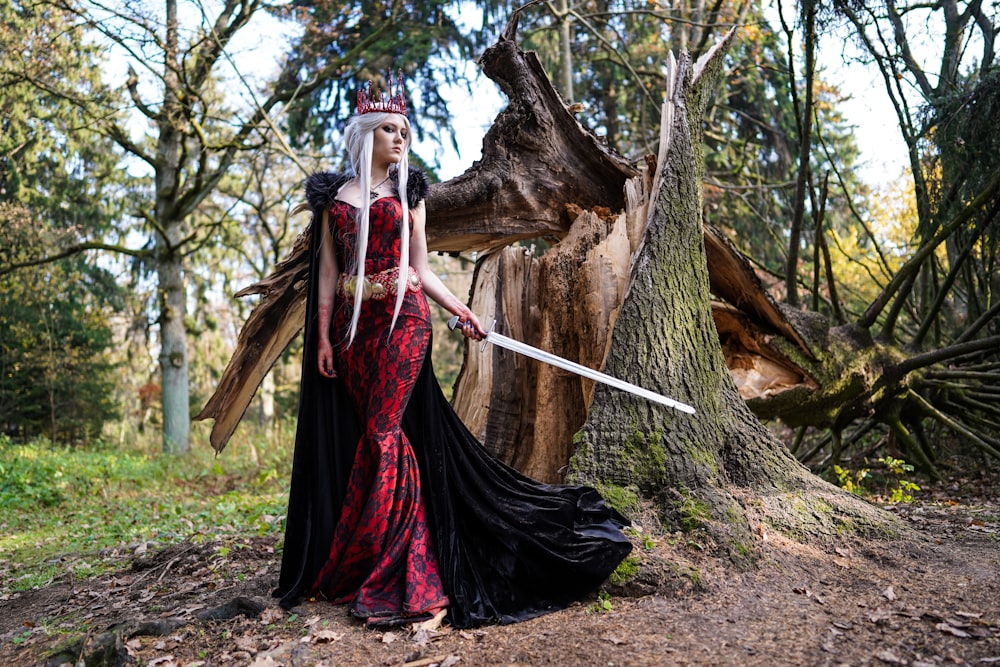 woman wearing red dress holding sword