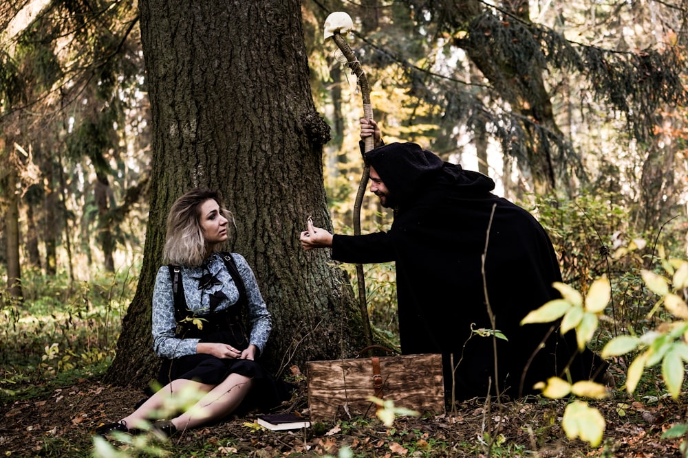 woman sitting beside tree