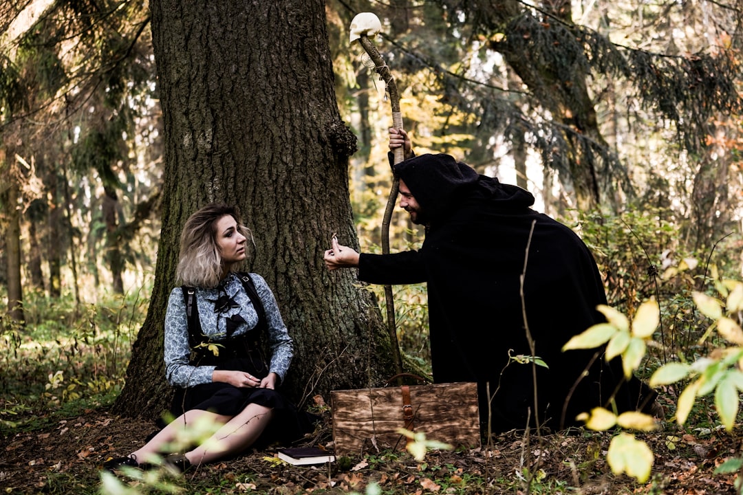 woman sitting beside tree,