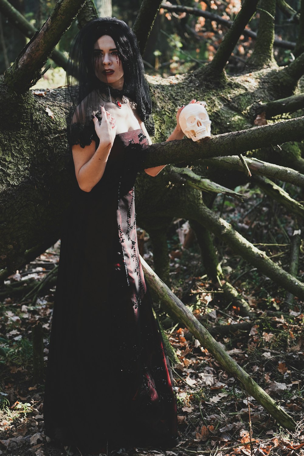 woman standing beside fallen tree