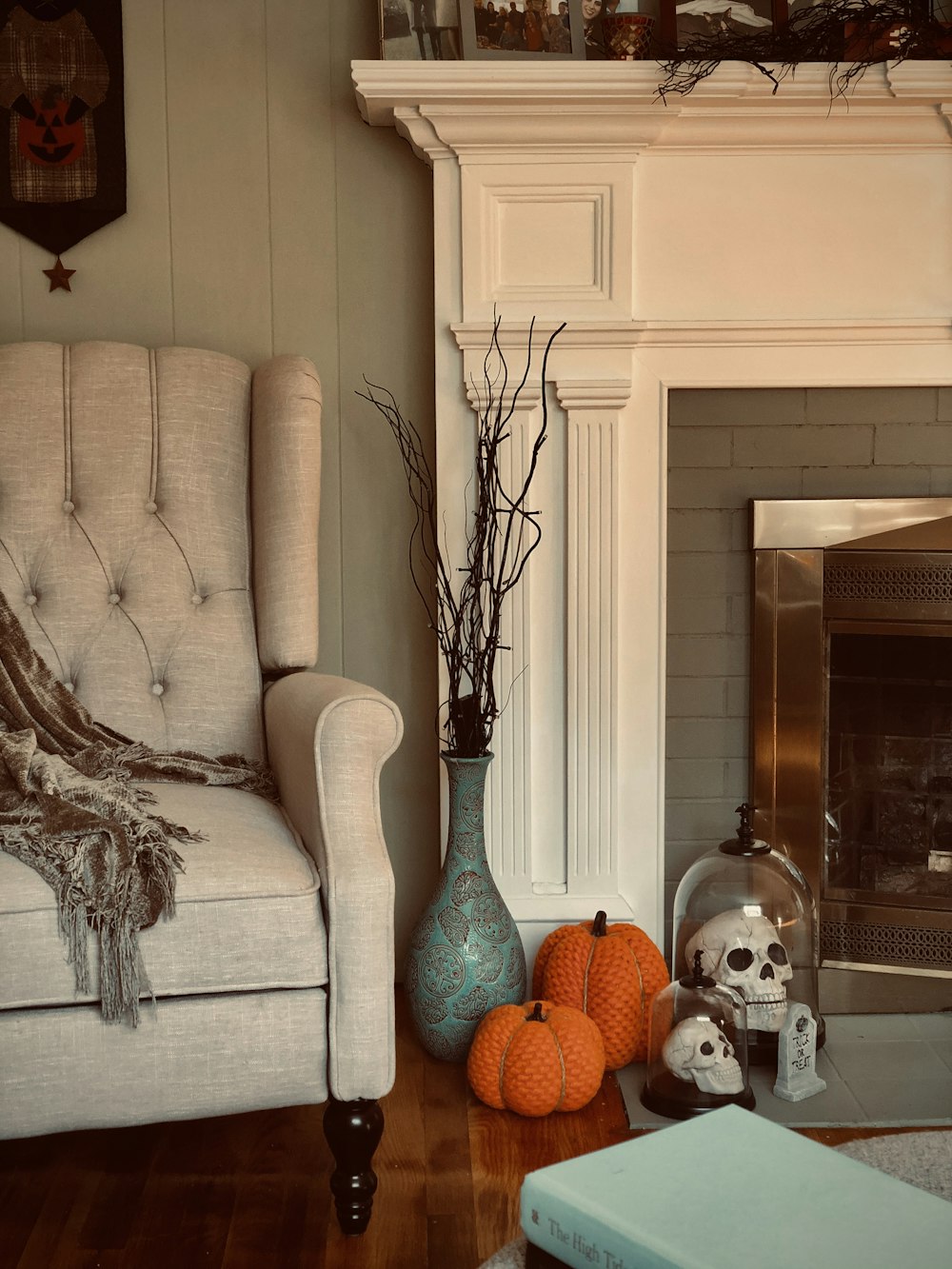 pumpkins and skull decors near fireplace