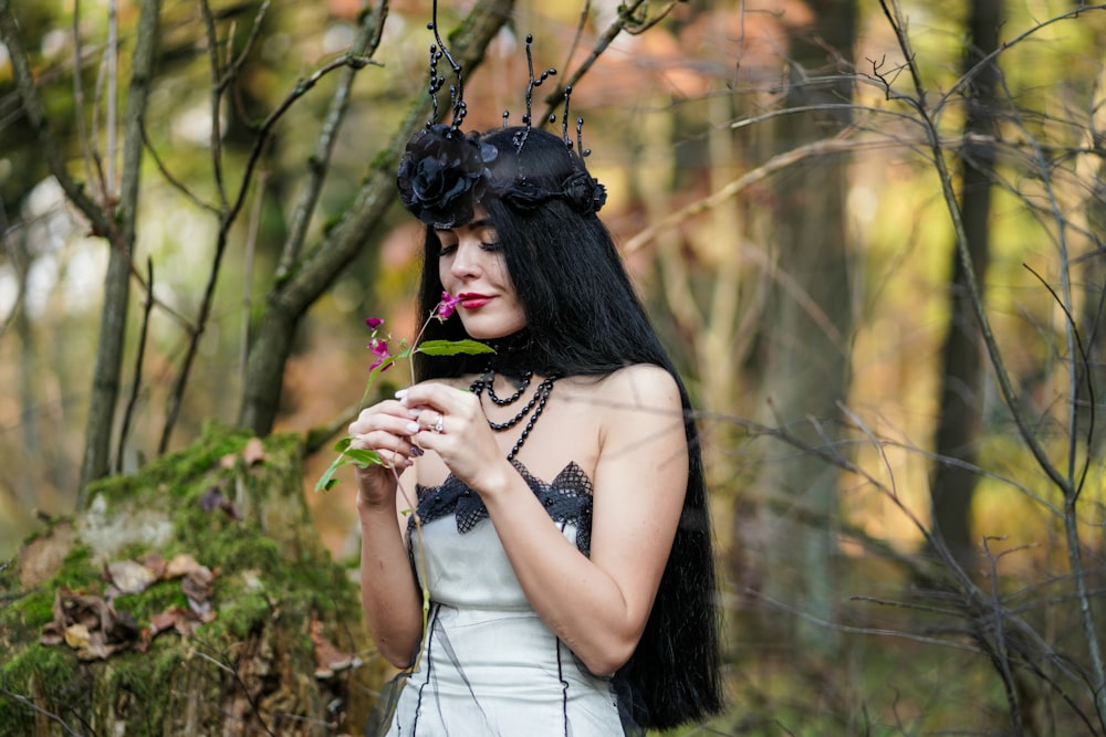 woman wearing white and black dress holding flower