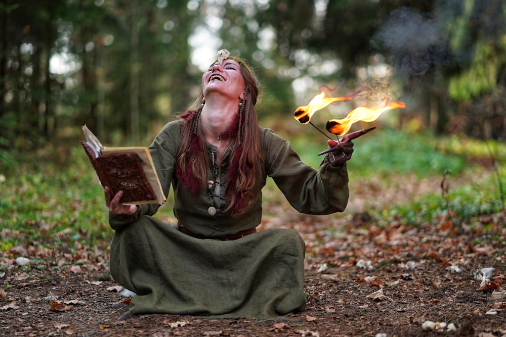 woman holding book and fire