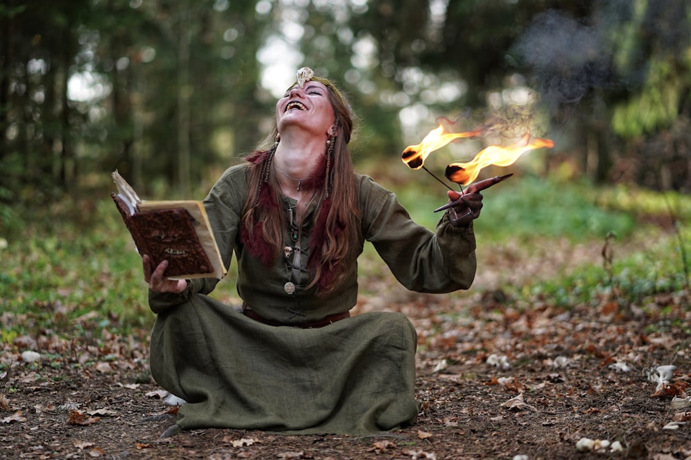 woman holding book and fire