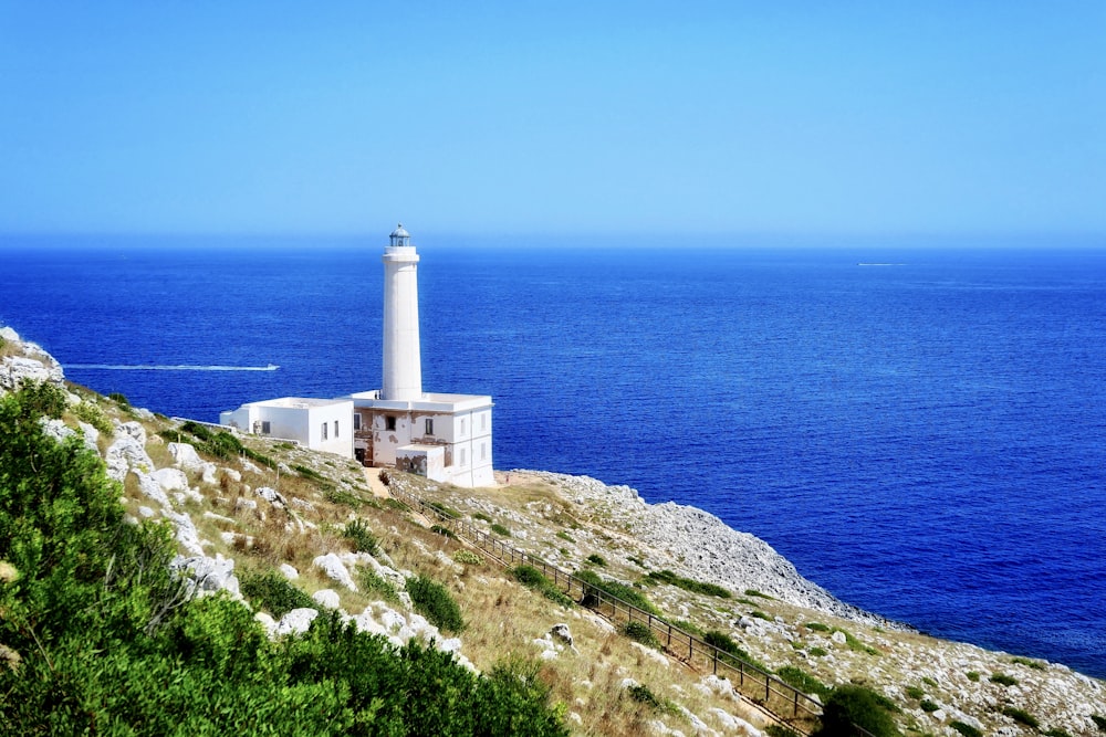 white lighthouse at a cliff