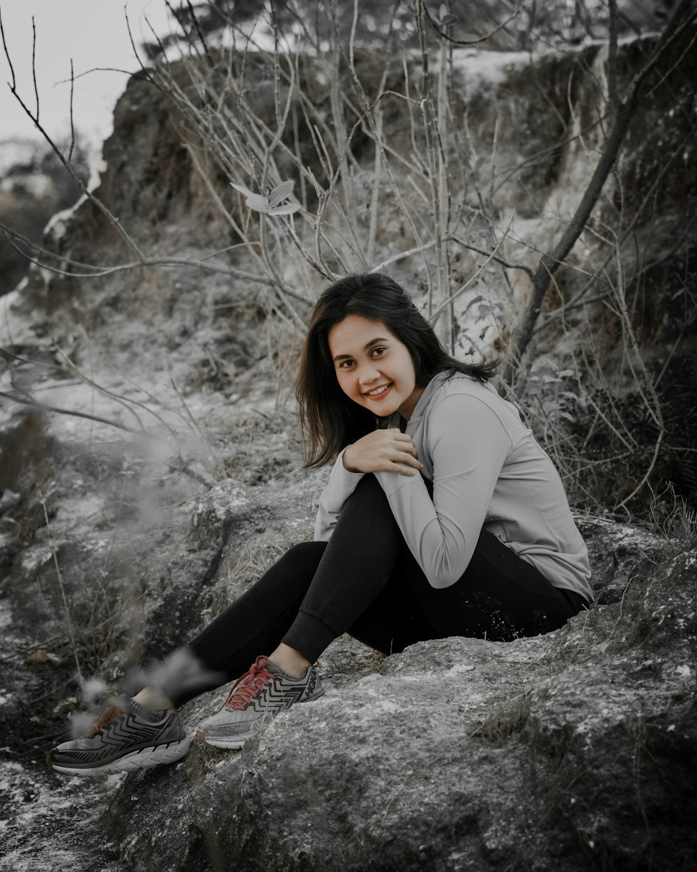 woman sitting on grey surface