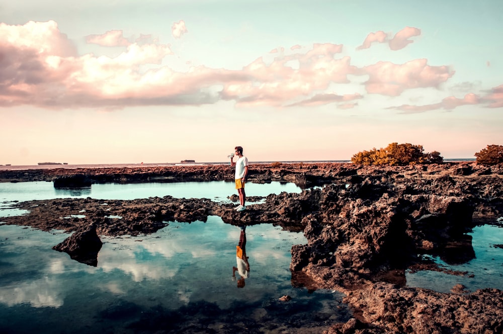 person standing on rock during daytime