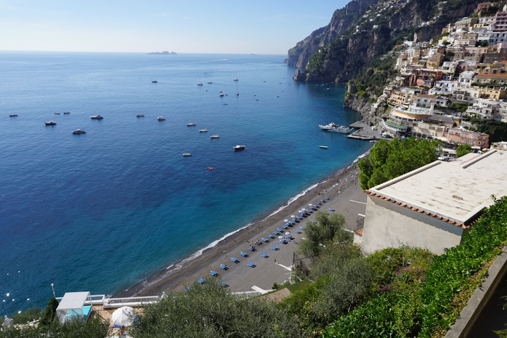 concrete buildings beside sea during daytime