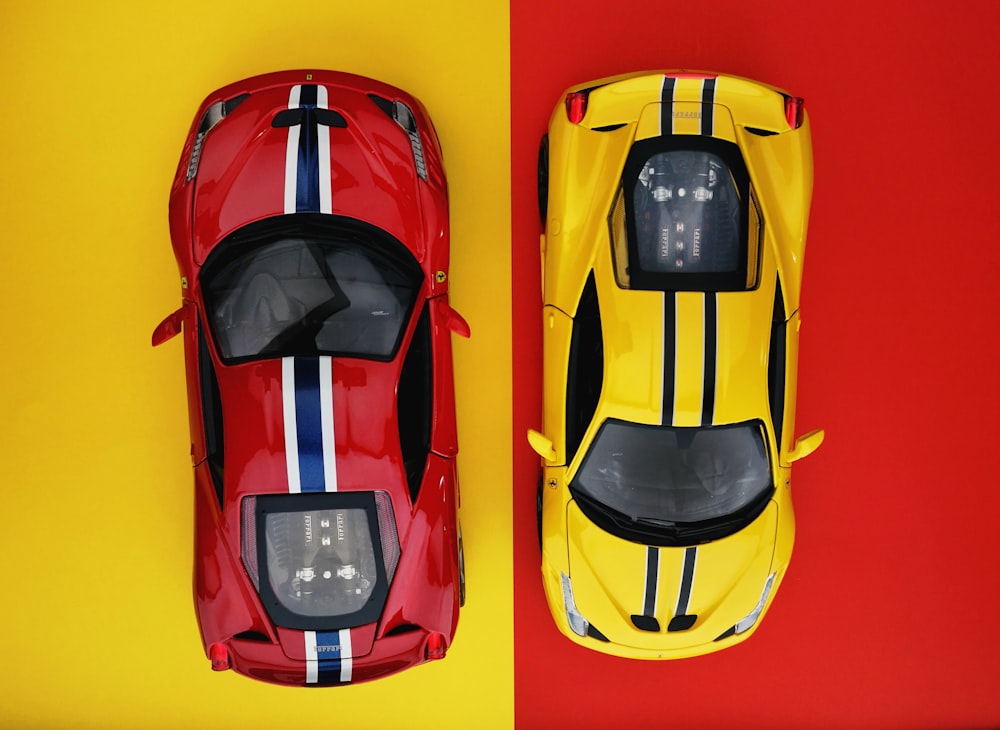 two red and yellow coupe diecast models on red and yellow background