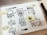 A hand-drawn flowchart on a white paper sheet features various web interface sketches connected by arrows. Post-it notes with texts like 'V2' and 'YES' are attached to specific sections. A marker and part of a laptop are visible nearby.