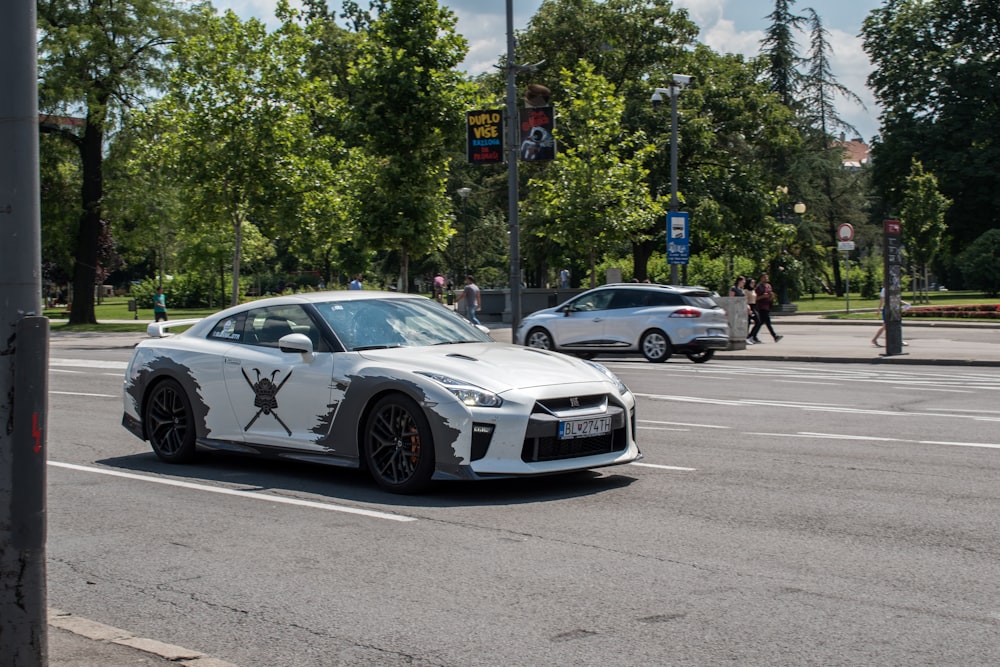 white coupe on road