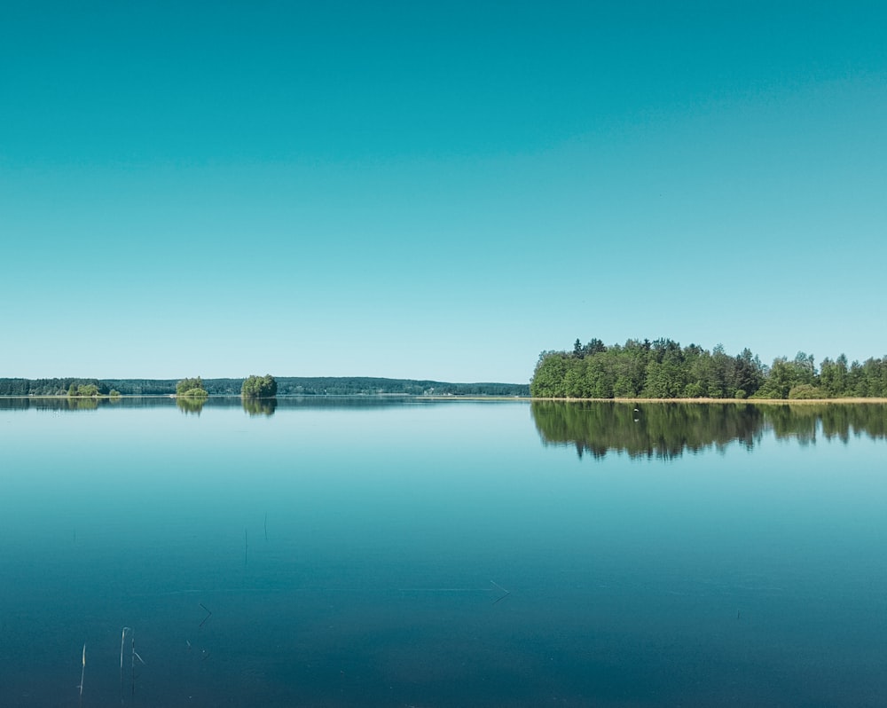 body of water under blue sky