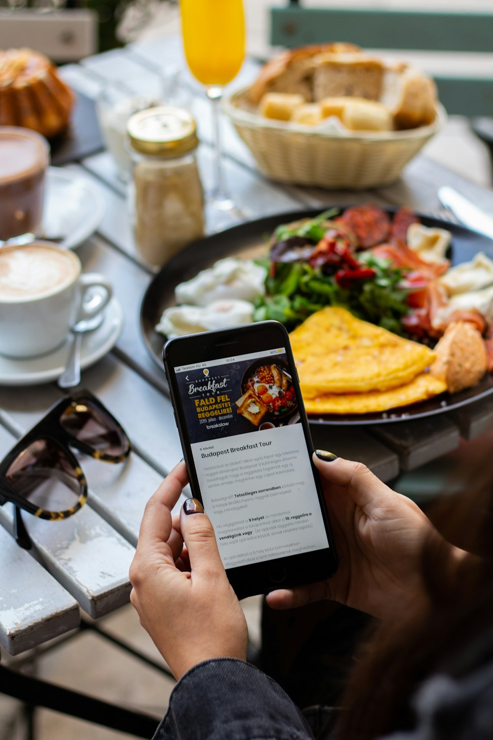 person wearing black dress shirt using black smartphone