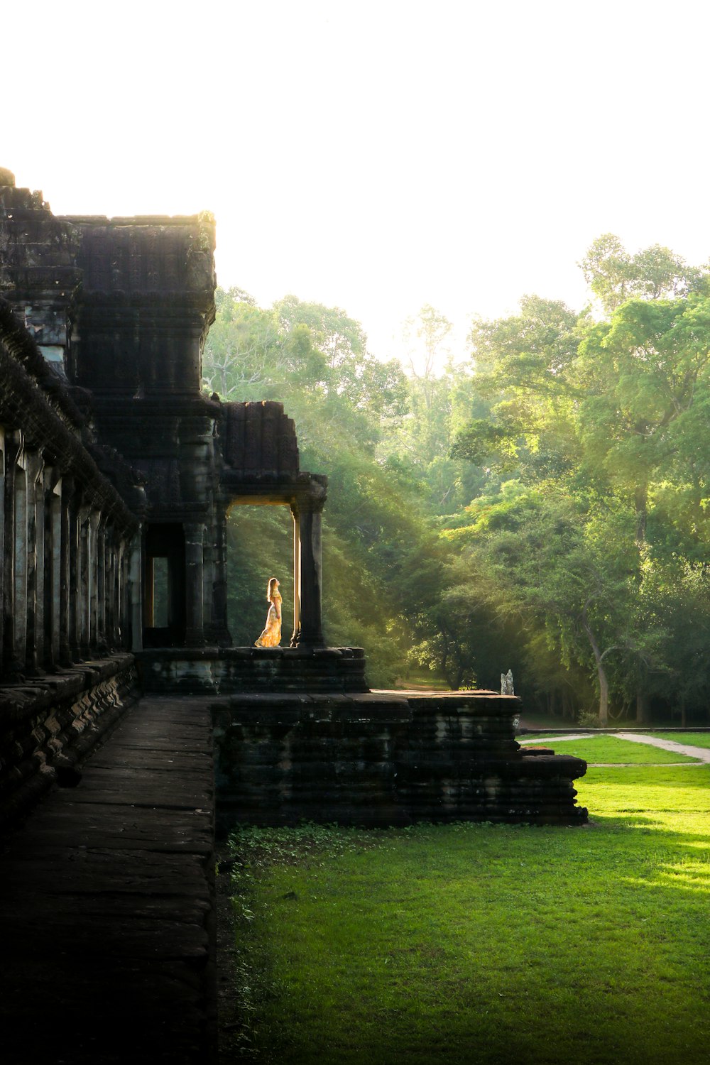 woman stands on temple under clear sky