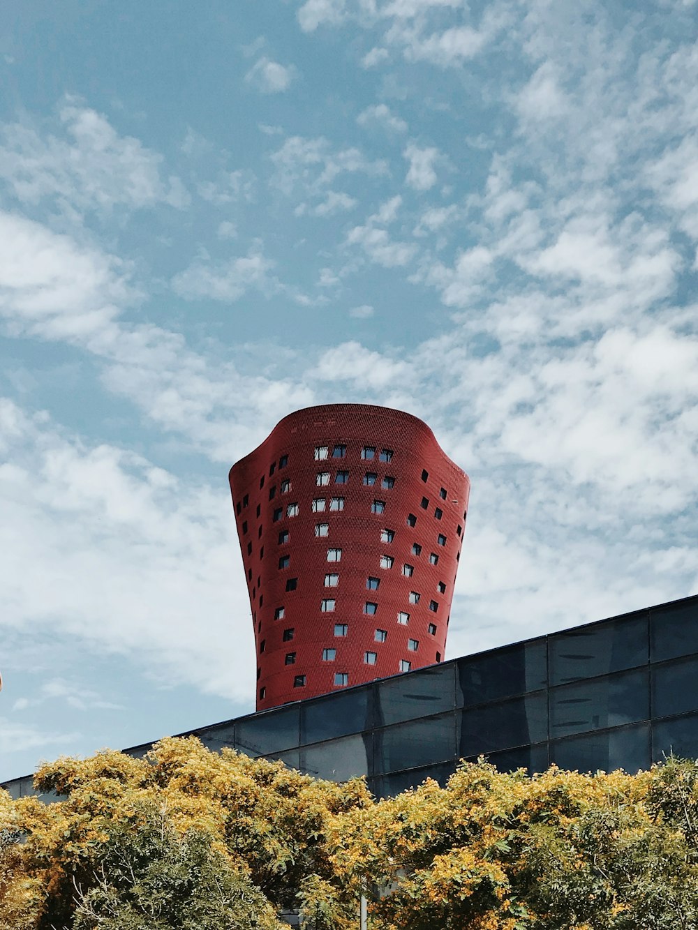 red architectural building under cloudy sky