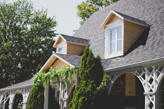 Yellow house with trees in front 