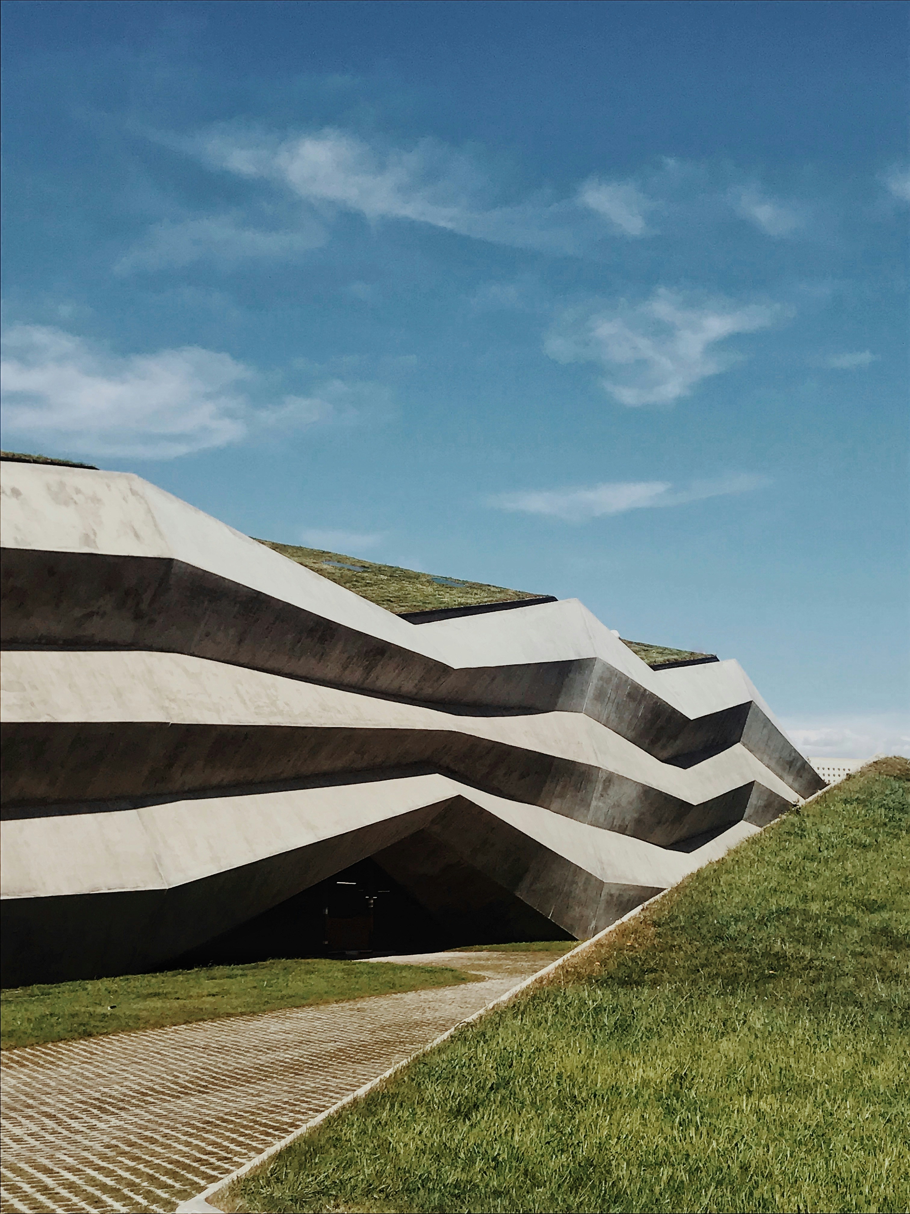 green grass field and brown concrete building